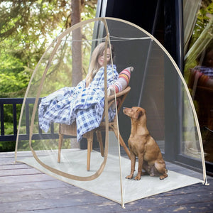 Relaxing on a wicker chair with a dog, enjoying the view from the TopGold 2-4 Person weatherproof pod on the patio